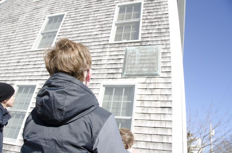 Andrew Porter looks up at a plaque on Cannon Street in honor of a man who died on the Titanic. BY GEORGIA SPARLING